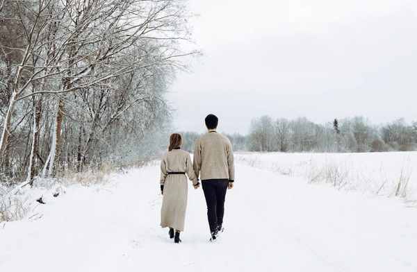 young couple wearing knitted sweaters 600nw 2099339629